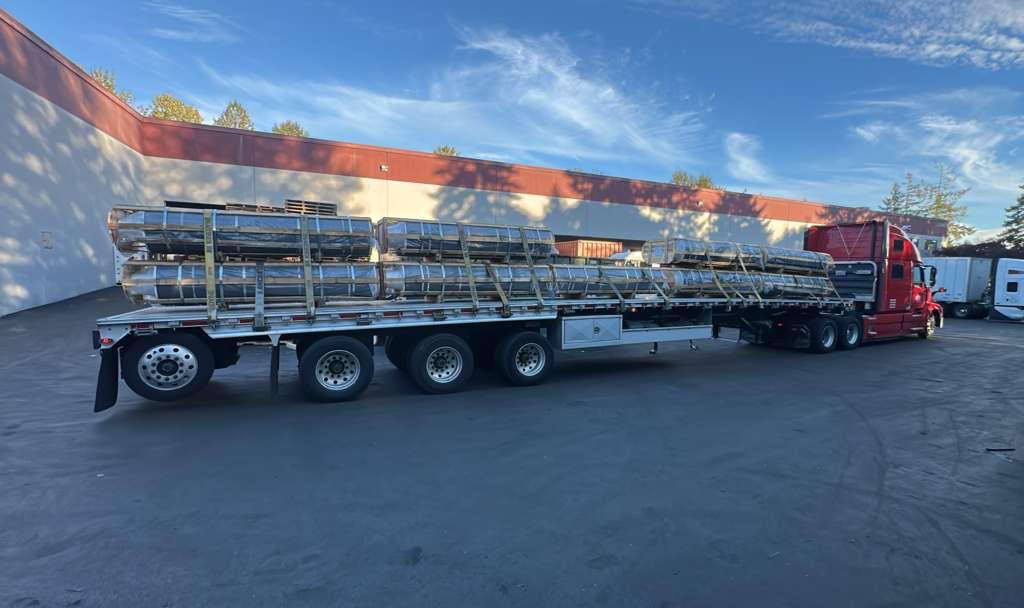 Coiled steel loaded on a Singh Trucklines flatbed